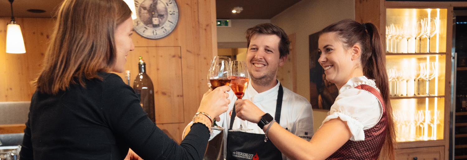 A service team toasts with drinks.